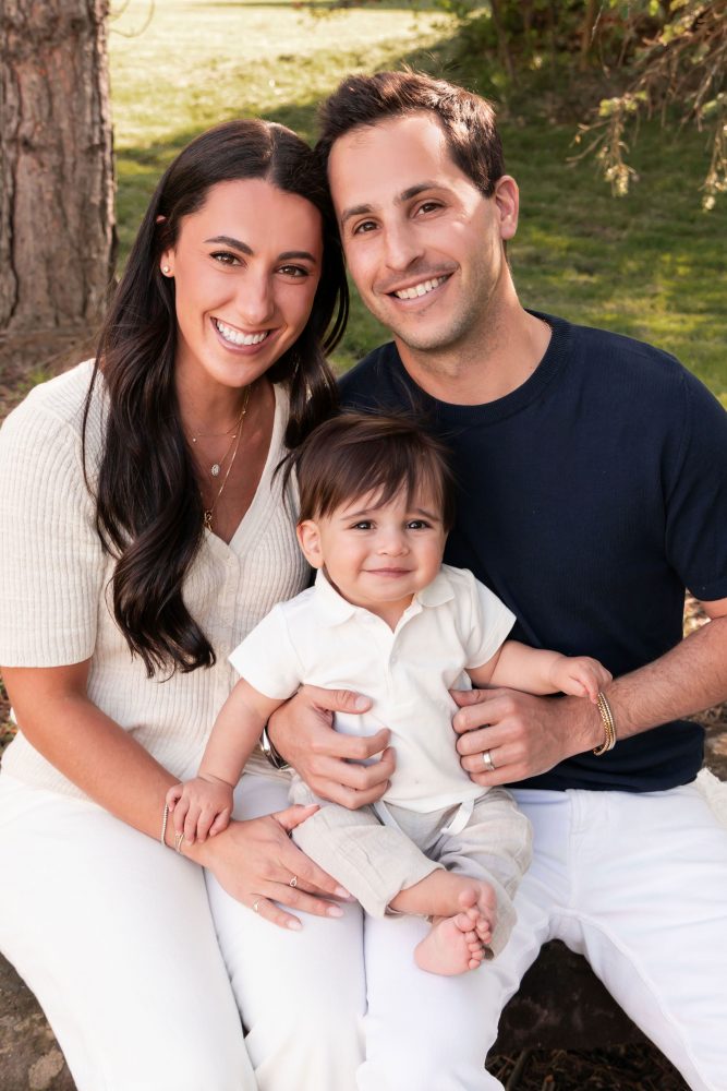 Happy family with their one-year-old baby boy enjoying an outdoor portrait session by Cleveland family photographer Allison Liffman Photography.