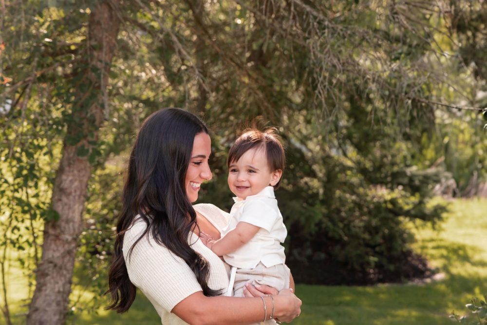 Happy family with their one-year-old baby boy enjoying an outdoor portrait session by Cleveland family photographer Allison Liffman Photography.