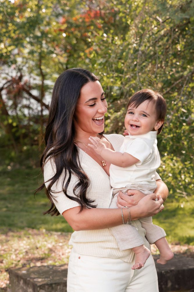 Happy family with their one-year-old baby boy enjoying an outdoor portrait session by Cleveland family photographer Allison Liffman Photography.