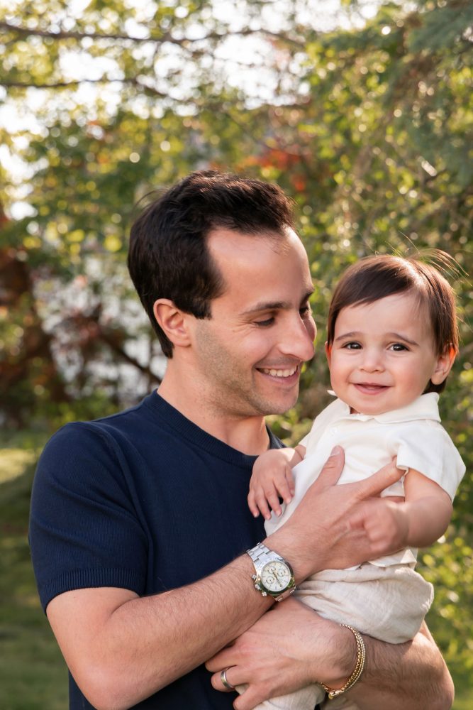 Natural outdoor family photos celebrating a baby's first birthday with parents in Cleveland, Ohio.