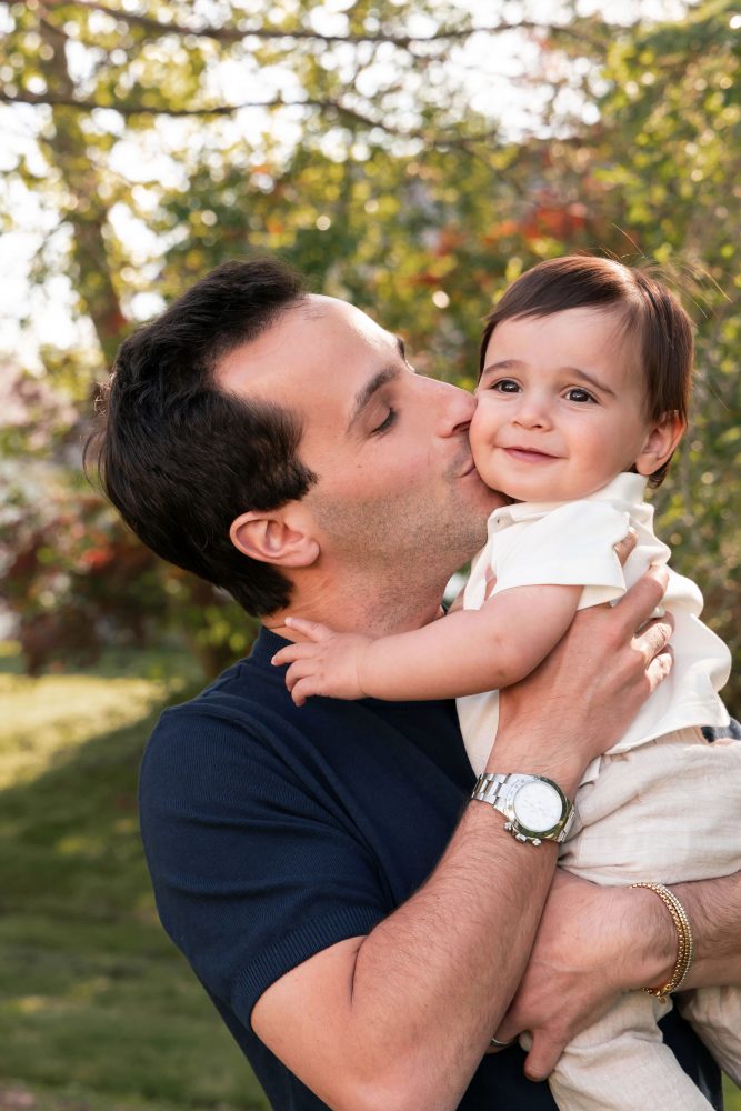 Natural outdoor family photos celebrating a baby's first birthday with parents in Cleveland, Ohio.