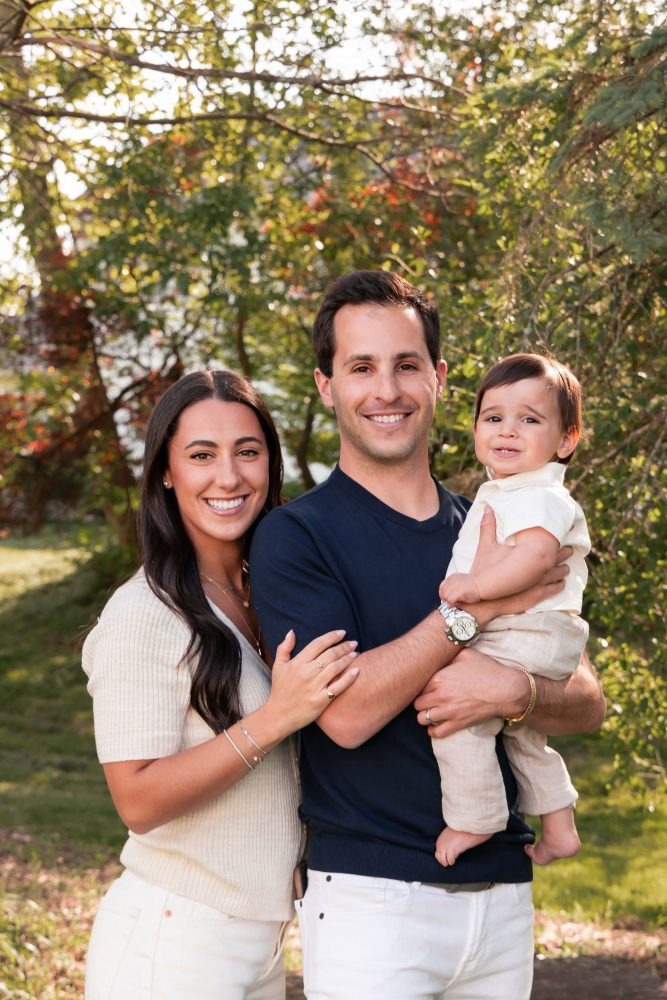 Natural outdoor family photos celebrating a baby's first birthday with parents in Cleveland, Ohio.