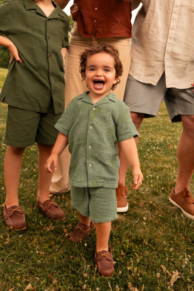 Outdoor family photography in Cleveland with three brothers playing together in the grass