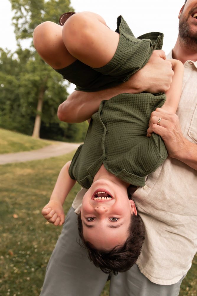 Outdoor family photography in Cleveland with three brothers playing together in the grass