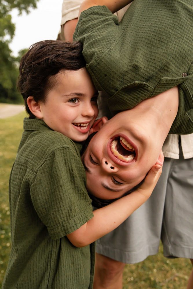 Outdoor family photography in Cleveland with three brothers playing together in the grass