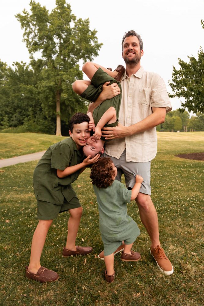 Outdoor family photography in Cleveland with three brothers playing together in the grass