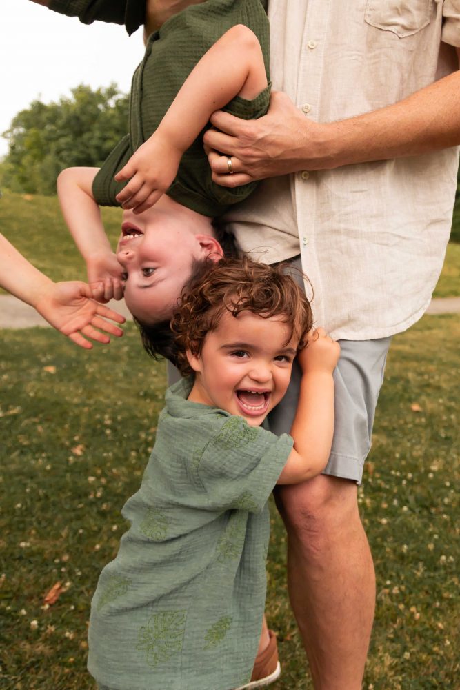 Natural family portraits of parents and three boys during a Cleveland summer sunset