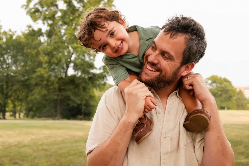 Natural family portraits of parents and three boys during a Cleveland summer sunset