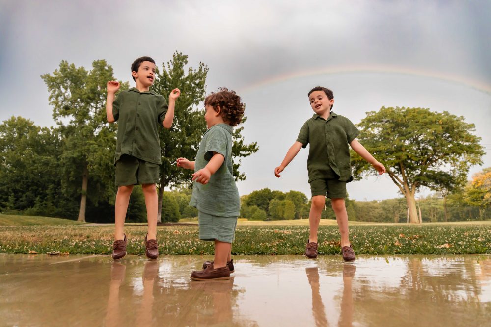 Natural family portraits of parents and three boys during a Cleveland summer sunset
