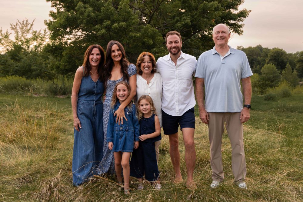 Cleveland extended family photographer capturing a family together at sunset in a field