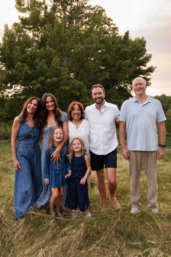 Cleveland extended family photographer capturing a family together at sunset in a field