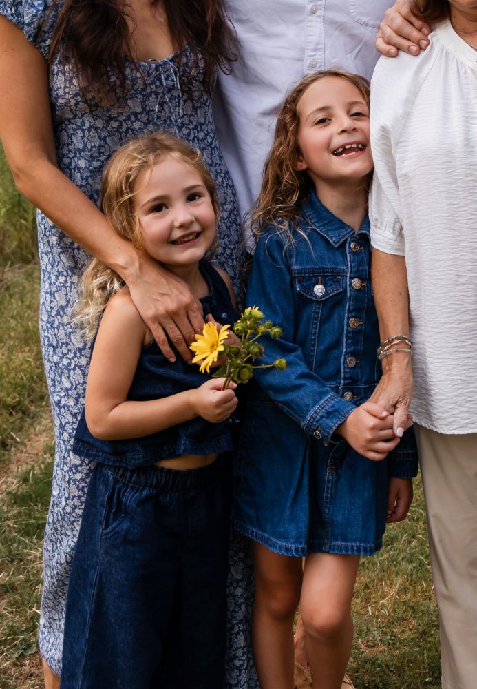 Warm candid moment between sisters during an extended family session in Cleveland