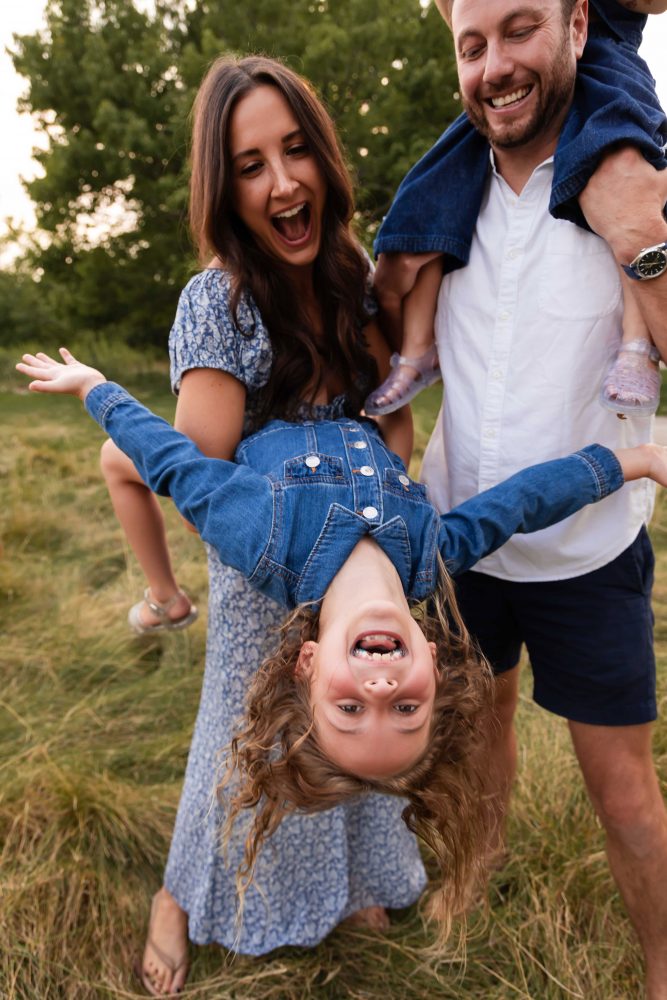 Family gathered together in a field during a golden hour Cleveland photography session