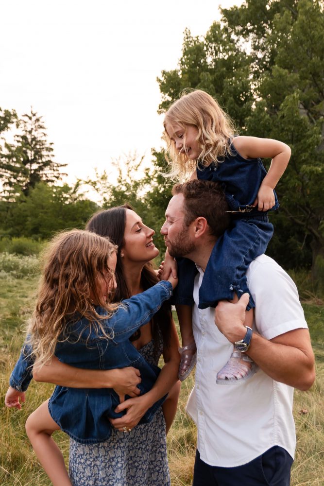 Family smiling together during a beautiful Cleveland sunset photography session