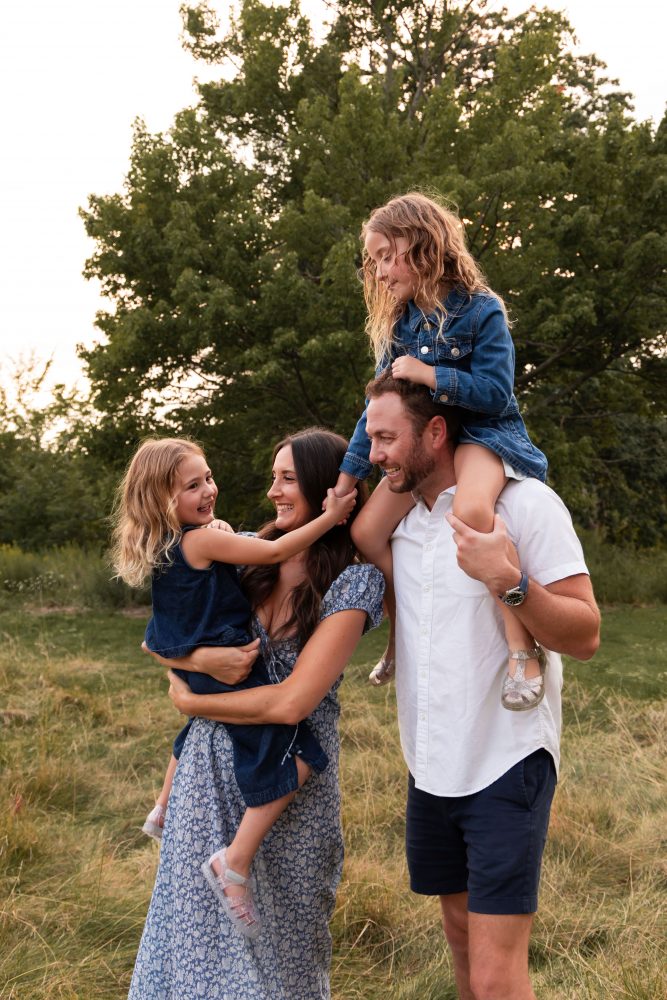 Family smiling together during a beautiful Cleveland sunset photography session