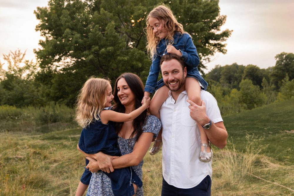 Family with daughter on dads shoulders during a beautiful Cleveland sunset photography session