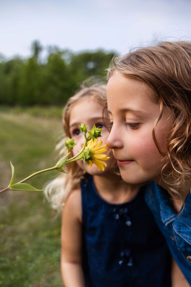 Young girls holding wildflowers during a Cleveland family photography session