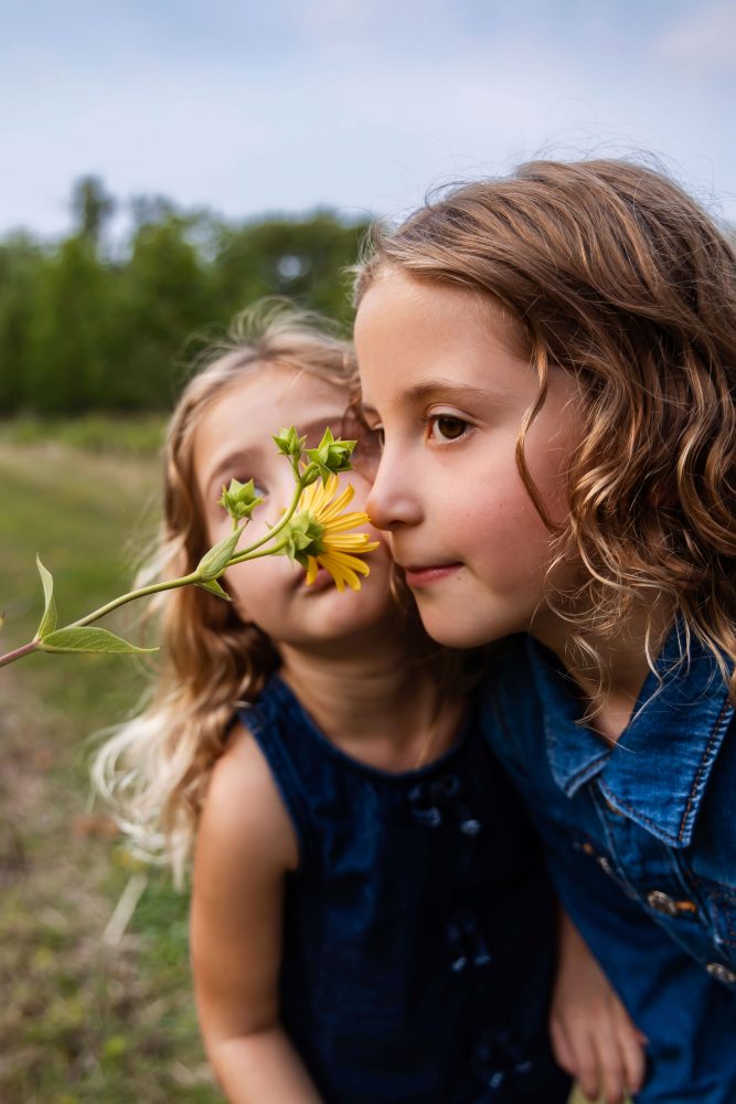 Young girls holding wildflowers during a Cleveland family photography session
