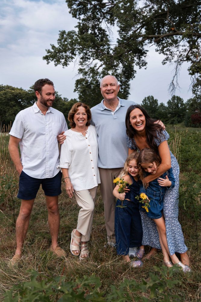 Warm candid moment between sisters during an extended family session in Cleveland