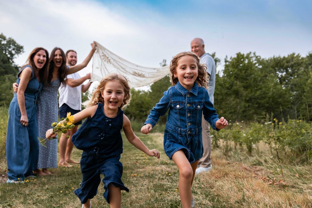 Two sisters laughing together during an outdoor Cleveland family photo session