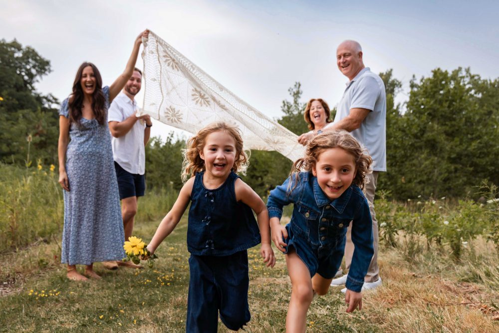 Warm candid moment between sisters during an extended family session in Cleveland