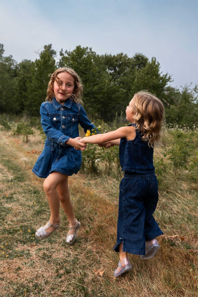 Two sisters laughing together during an outdoor Cleveland family photo session