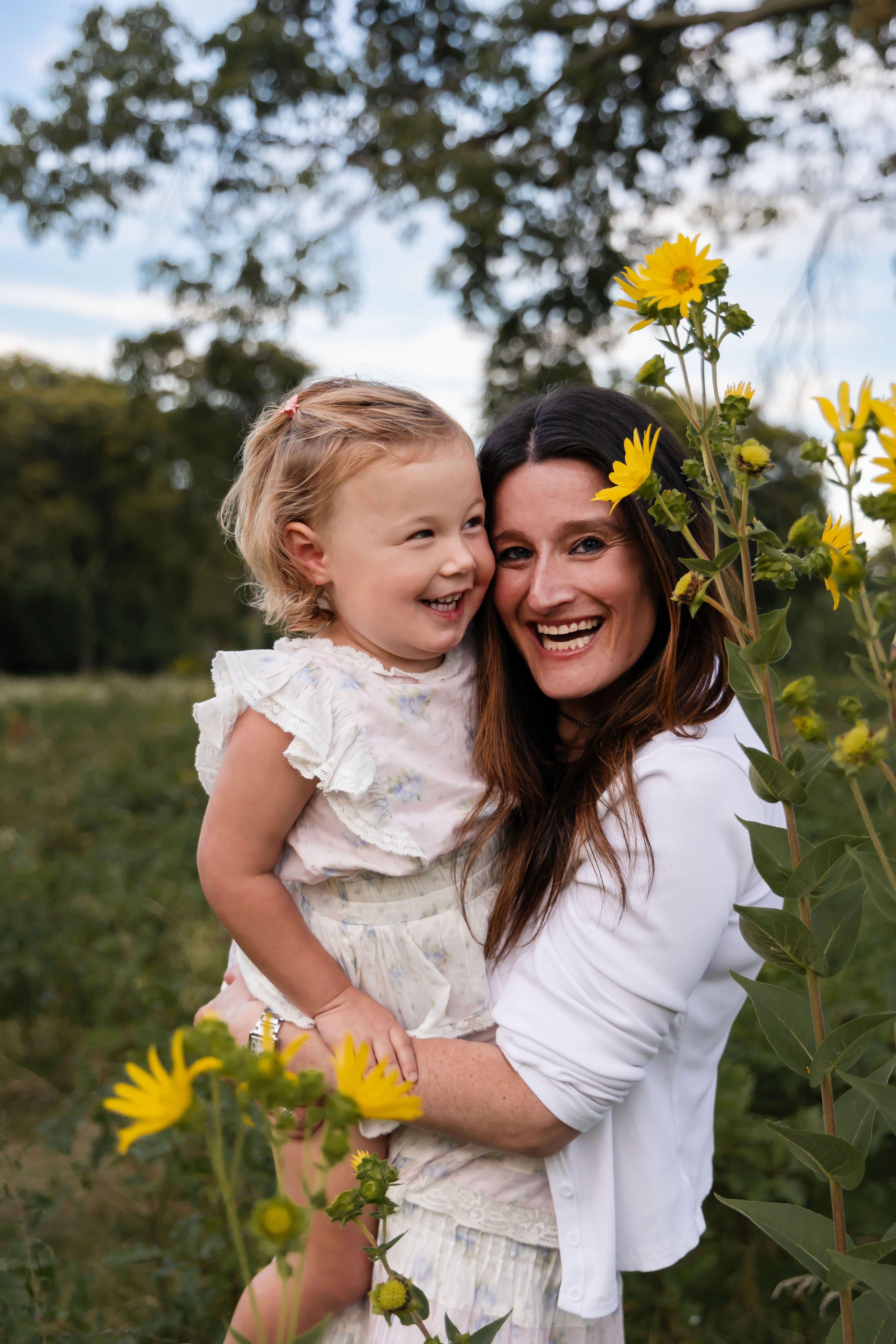 Cleveland family photographer Allison Liffman captures a mother and daughter cuddling in a wildflower field