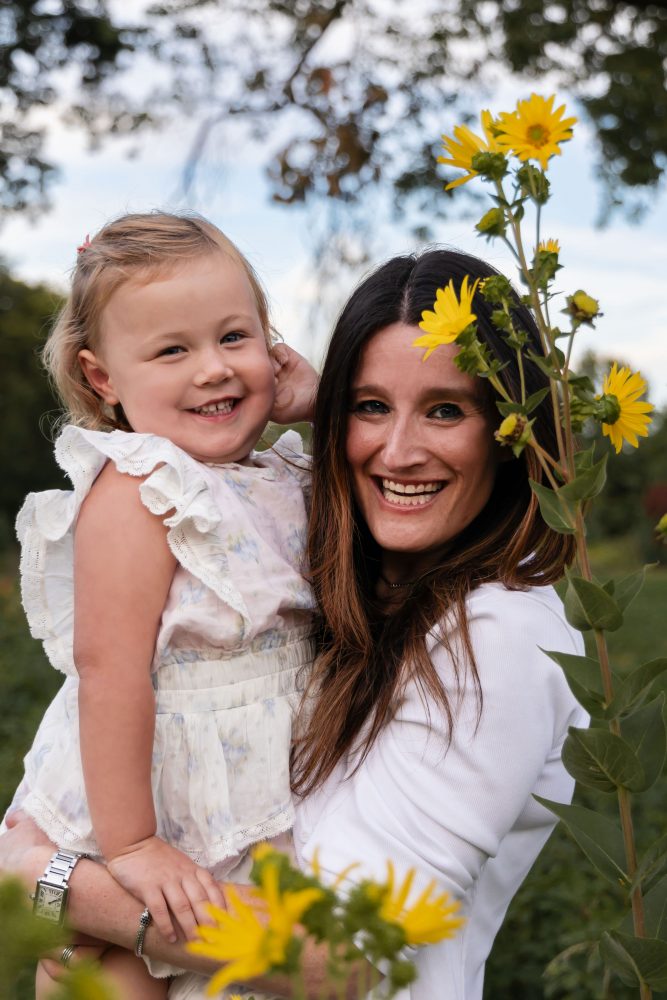 Cleveland family photographer Allison Liffman captures a mother and daughter cuddling in a wildflower field