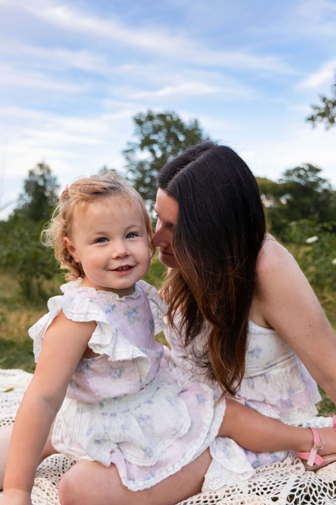 Mom sitting with her young daughter during a natural outdoor family photography session in Cleveland