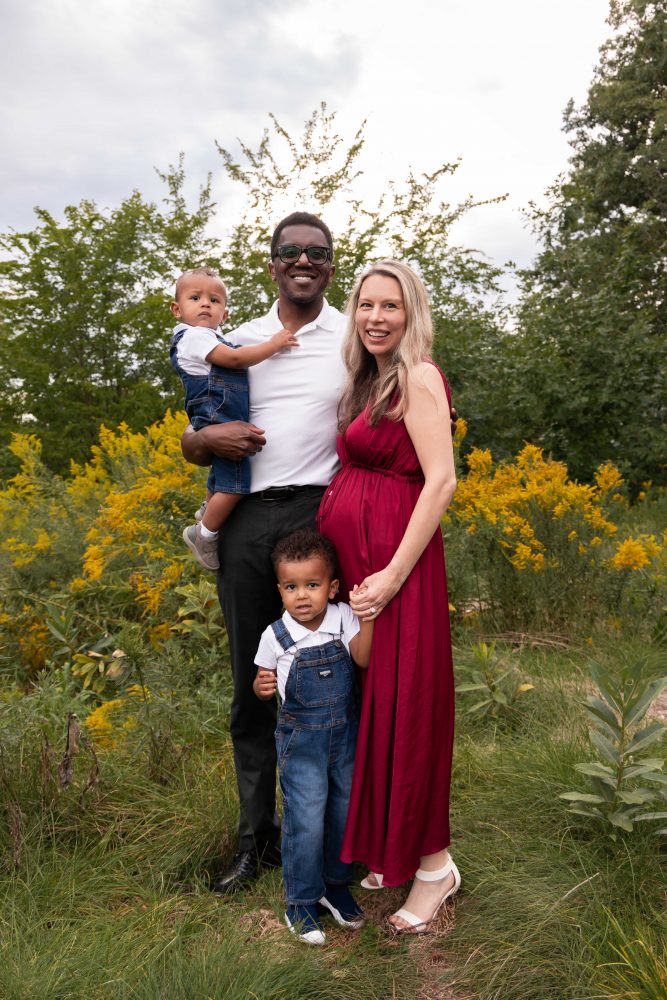 Cleveland family photography session of parents and two young boys surrounded by yellow wildflowers.