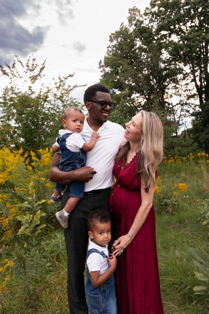 Cleveland family photography session of parents and two young boys surrounded by yellow wildflowers.