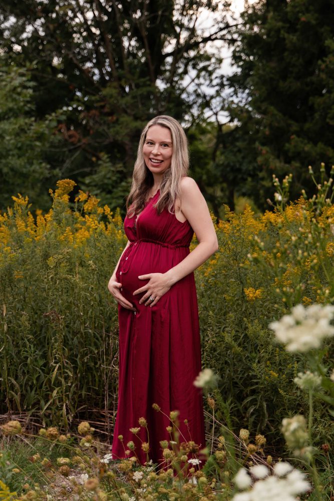 Cleveland maternity photography portrait of an expectant mother surrounded by wildflowers and tall grasses.
