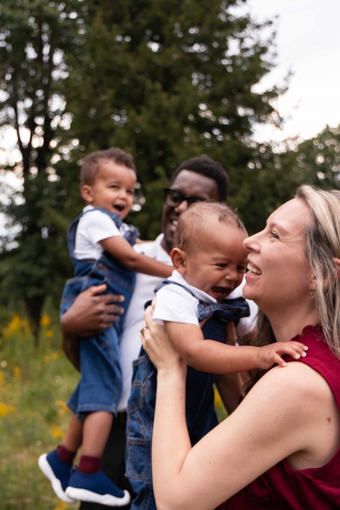 Family of four sharing a playful moment together during their Cleveland outdoor photography session.