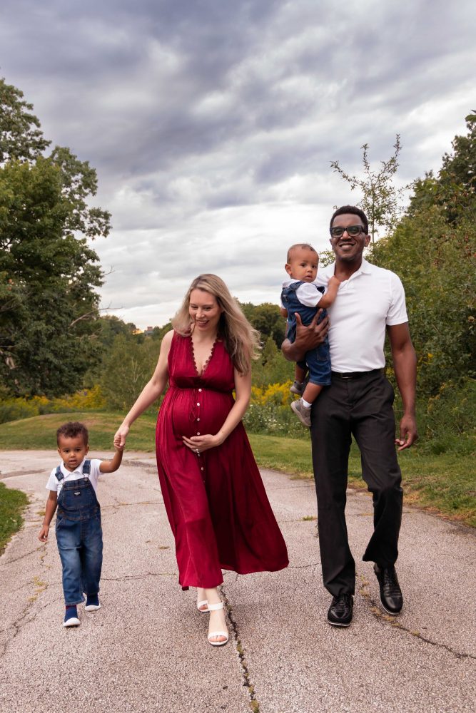 Parents and two children photographed in a natural meadow setting during a Cleveland family photography session.