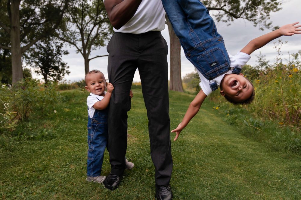 Parents and two children photographed in a natural meadow setting during a Cleveland family photography session.