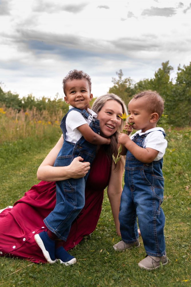 mother holding her two sons in the Cleveland parks during a sunset photoshoot