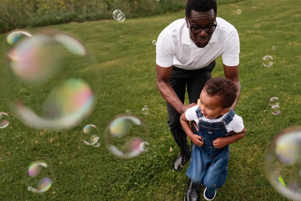 boy playing with bubbles during an outdoor family photoshoot in Cleveland, Ohio