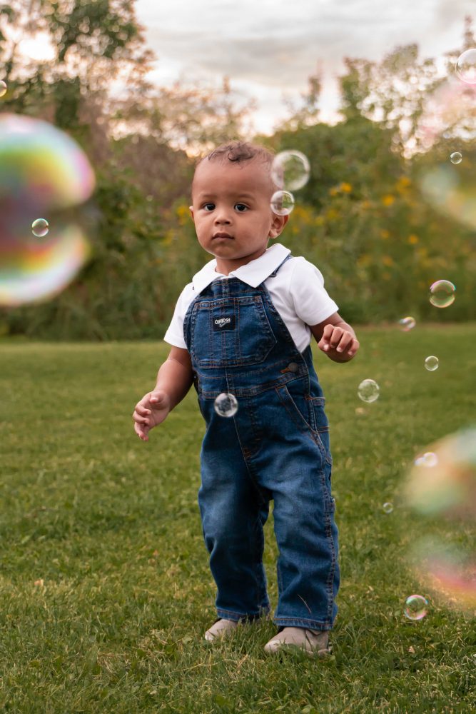 boy playing with bubbles during an outdoor family photoshoot in Cleveland, Ohio