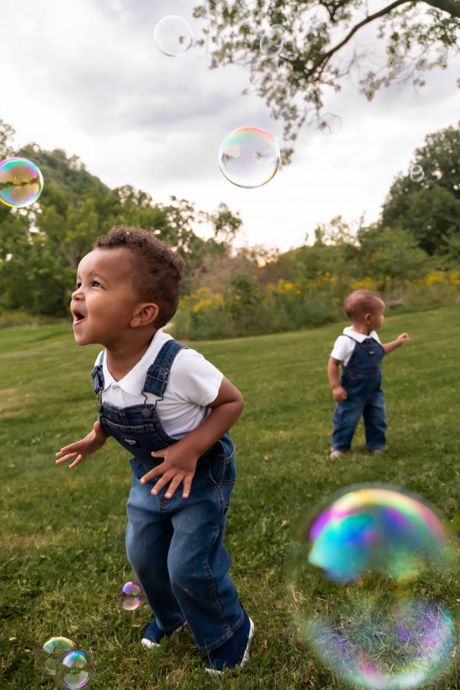 boy playing with bubbles during an outdoor family photoshoot in Cleveland, Ohio