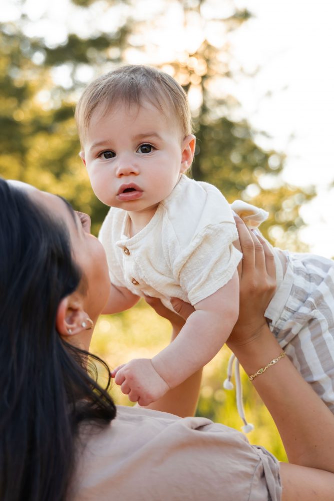 A baby boy held by his mother during an outdoor family photography session in Cleveland, Ohio.