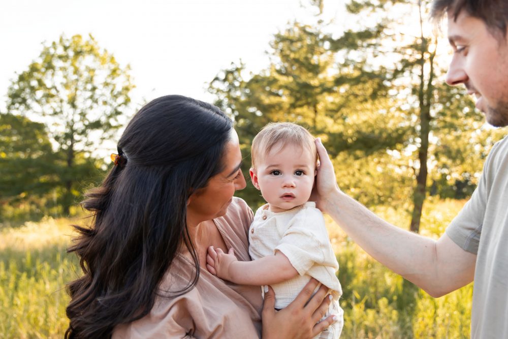 A baby boy held by his mother during an outdoor family photography session in Cleveland, Ohio.