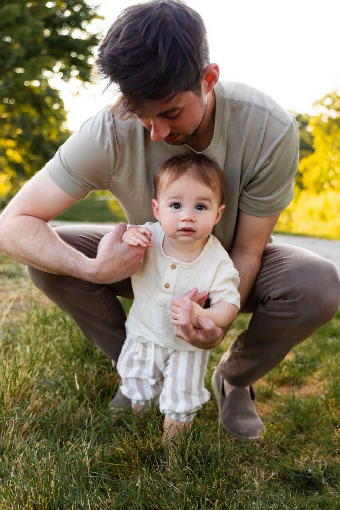 A father cuddling his son during an outdoor sunset photoshoot in Cleveland, Ohio.