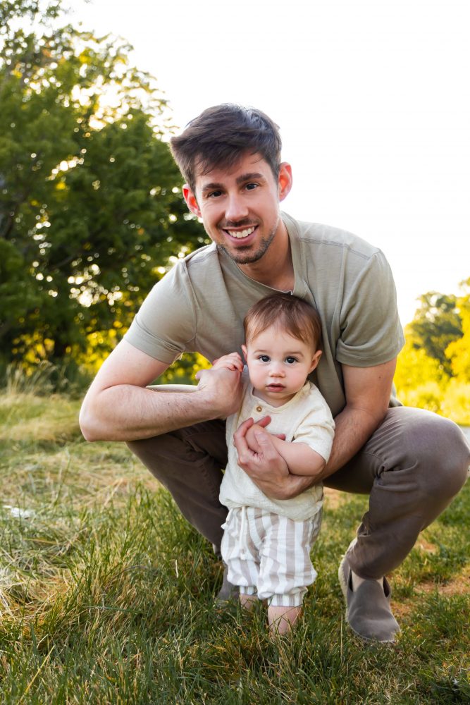 A father cuddling his son during an outdoor sunset photoshoot in Cleveland, Ohio.