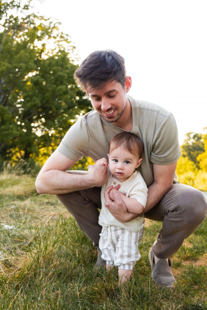 A father cuddling his son during an outdoor sunset photoshoot in Cleveland, Ohio.