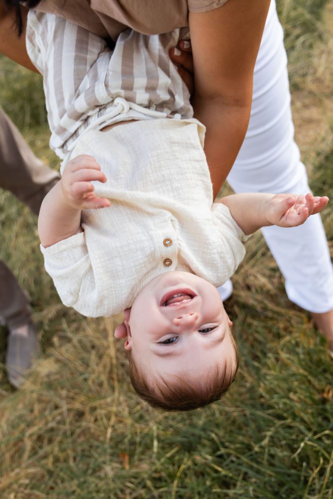 Mother and son play together during an outdoor sunset family photoshoot in Cleveland, Ohio