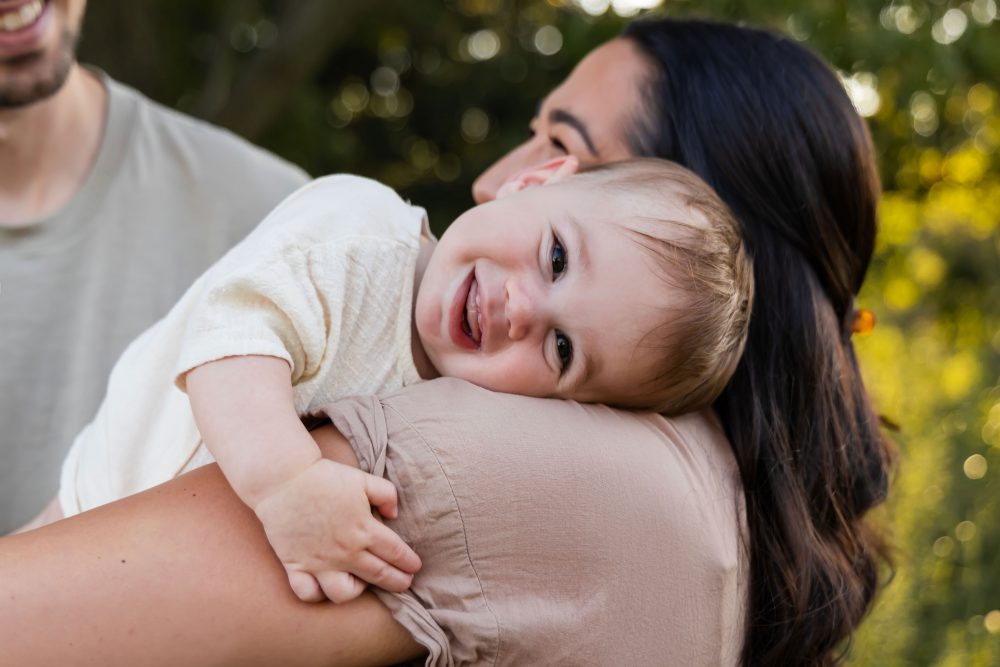 Cleveland family photographer Allison Liffman Photography captures a joyful candid moment between a mother and her baby boy outdoors.
