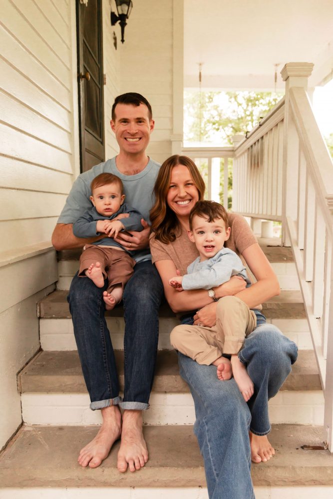 Natural family portraits of a mom, dad, baby, and toddler sitting together on a brick porch in Cleveland, Ohio
