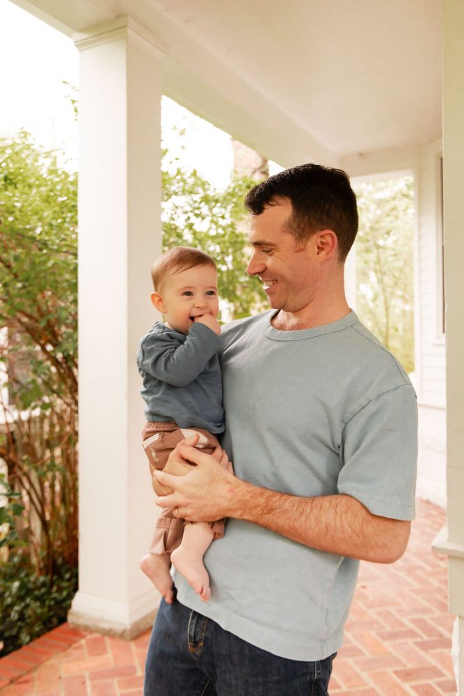 Cleveland, Ohio family portraits featuring a father and toddler sharing a relaxed porch moment.
