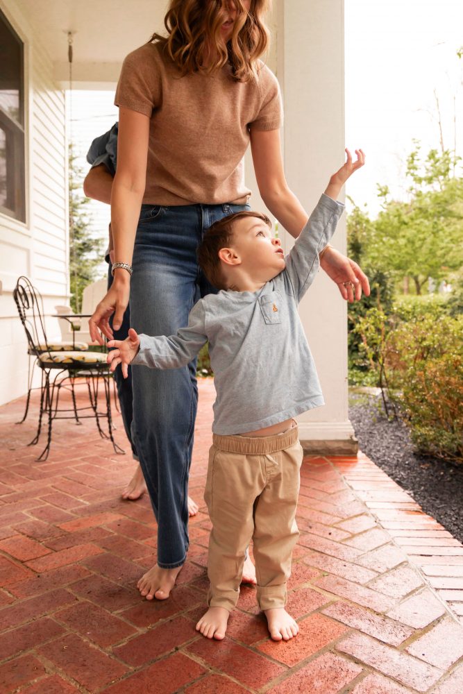 Cleveland family photographer captures a toddler exploring his front porch during a relaxed family session.