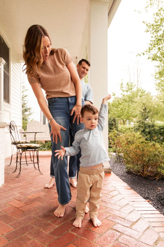 Cleveland family photographer captures a toddler exploring his front porch during a relaxed family session.